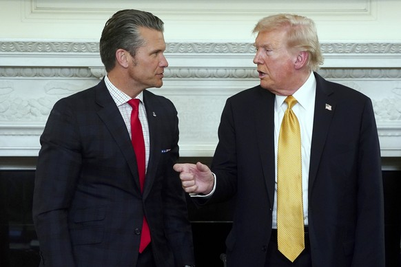 epa12477189 US President Donald Trump (R) and US Secretary of Defense Pete Hegseth (L) during a roundtable with the Homeland Security Task Force in the State Dining Room of the White House in Washingt ...