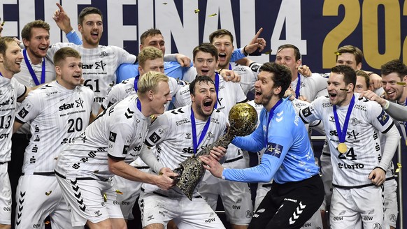 Kiel&#039;s captain Domagoj Duvnjak holds the trophy when his team celebrates after winning he Final Four Champions League handball final match between THW Kiel and FC Barcelona in Cologne, Germany, T ...
