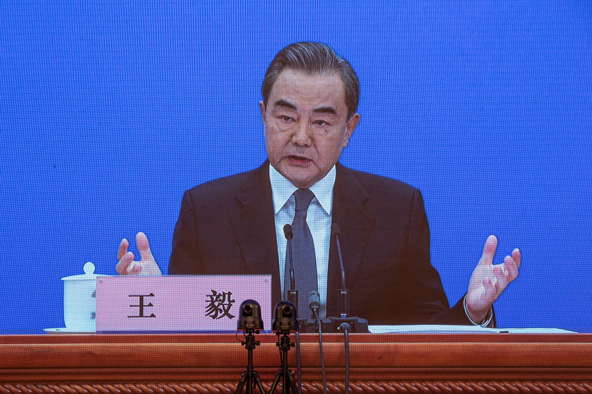 epa08440680 Chinese Foreign Minister Wang Yi is seen on a screen as he speaks to reporters during an online press conference in Beijing, China, 24 May 2020. China held the Chinese People's Politi ...