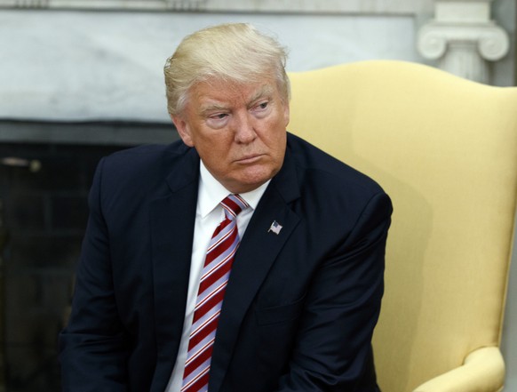 President Donald Trump talks to reporters during a meeting with Dr. Henry Kissinger, former Secretary of State and National Security Advisor under President Richard Nixon, in the Oval Office of the Wh ...