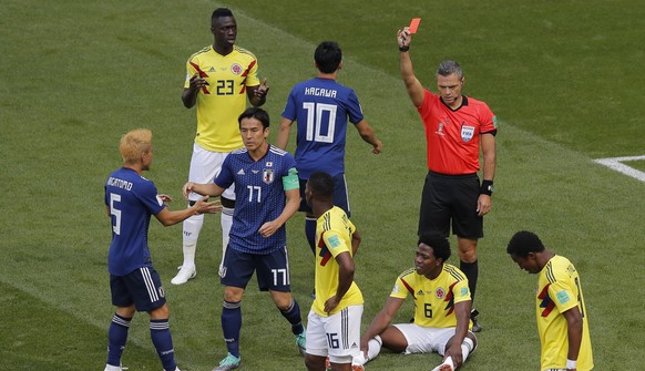 Referee Damir Skomina from Slovenia shows a red card to Colombia&#039;s Carlos Sanchez, on the ground, during the group H match between Colombia and Japan at the 2018 soccer World Cup in the Mordavia  ...