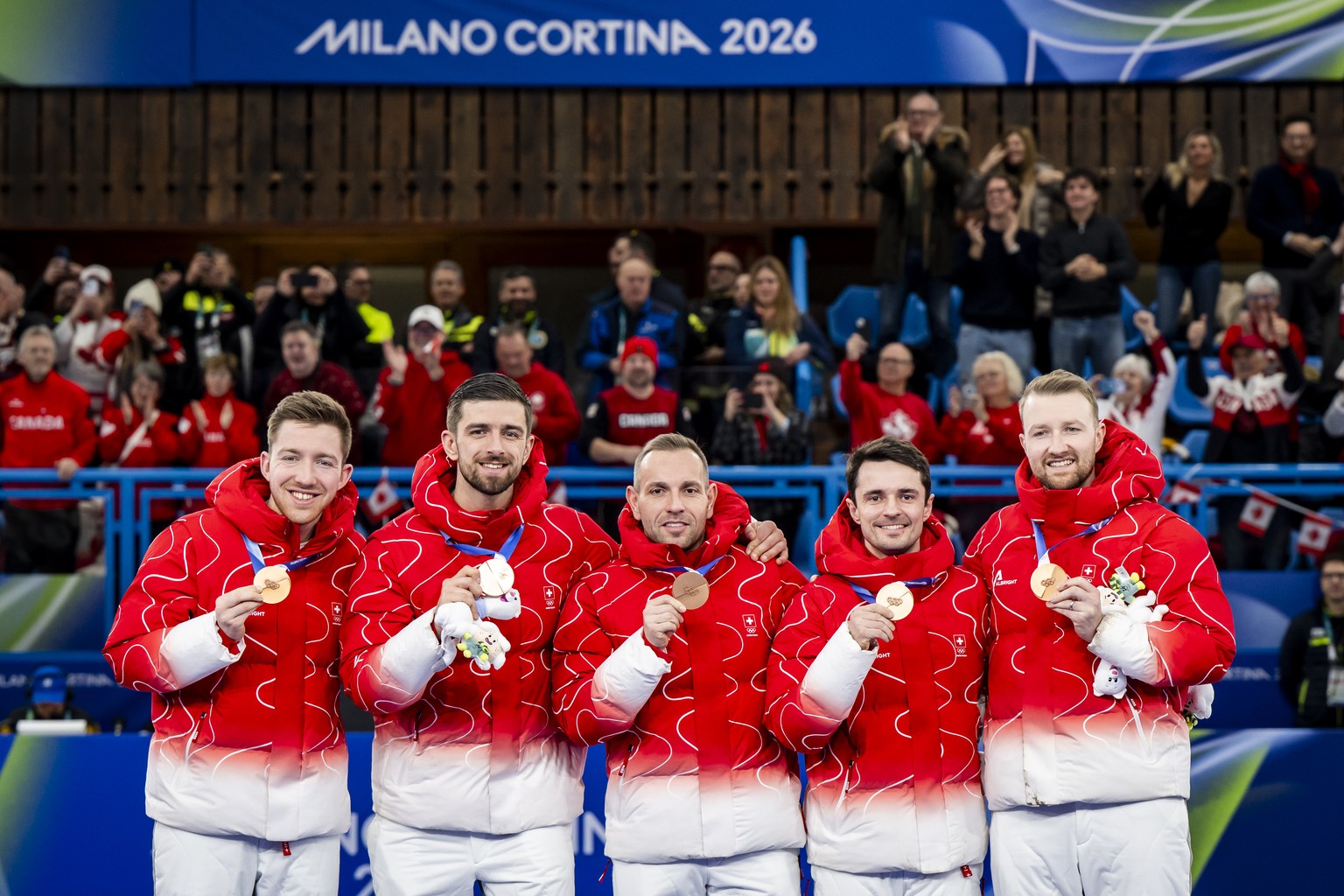 Bronze medalists Kim Schwaller (substitute), Pablo Lachat-Couchepin, Sven Michel, Benoit Schwarz-van Berkel and Yannick Schwaller of Switzerland, from left to right, celebrate during the men's cu ...