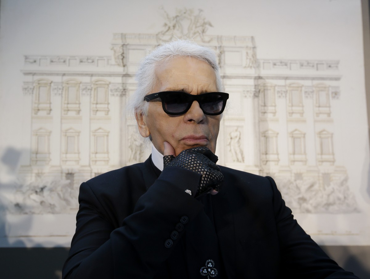 FILE - In this Monday, Jan. 28, 2013 file photo, Karl Lagerfeld poses for photographers prior to the start of a press conference, in Rome. Chanel's iconic couturier, Karl Lagerfeld, whose accompl ...
