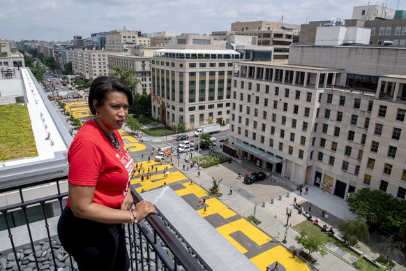 In this image provided by the Executive Office of the Mayor, District of Columbia Mayor Muriel Bowser stands on the rooftop of the Hay Adams Hotel near the White House and looks out at the words 'Blac ...