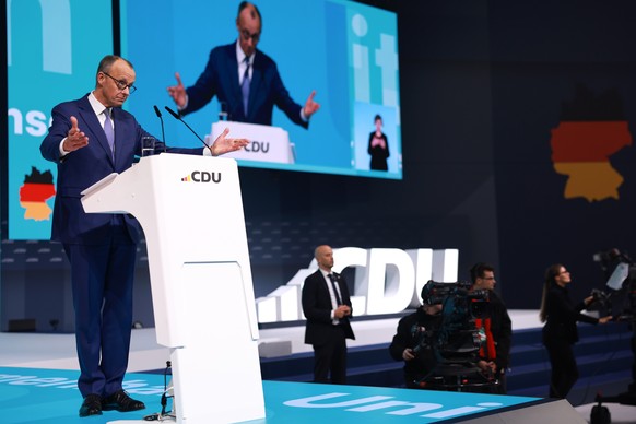 epa11872962 Chairman of the Christian Democratic Union (CDU) party and faction Friedrich Merz (L) speaks during the Christian Democratic Union (CDU) federal party conference in Berlin, Germany, 03 Feb ...