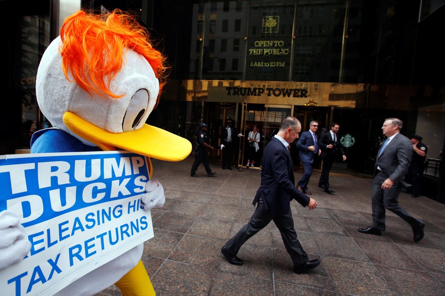 An activist by the name of DJ Quacker holds a sign asking Republican presidential nominee Donald Trump to release his tax forms, outside of Trump Tower in New York City, New York, U.S., September 6, 2 ...