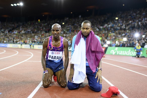 Mo Farah of Great Britain, left, kneels on the track next to high jumper Mutaz Essa Barshim of Qatar after the 5000m Men, during the Weltklasse IAAF Diamond League international athletics meeting in t ...