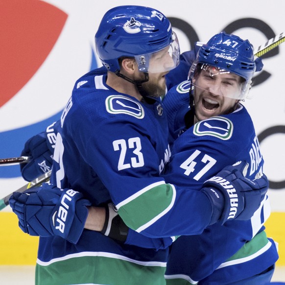 Vancouver Canucks&#039; Alexander Edler (23), of Sweden, and Sven Baertschi (47), of Switzerland, celebrate Baertschi&#039;s goal against the Arizona Coyotes during the second period of an NHL hockey  ...