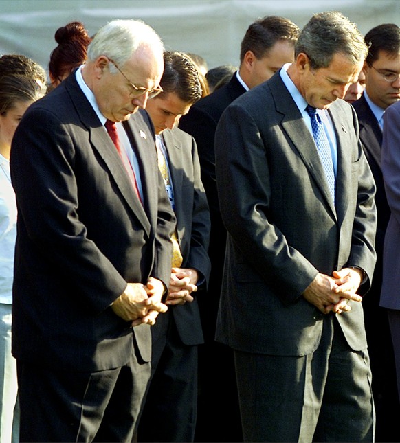 President Bush and Vice President Dick Cheney join hundreds of White House employees in a moment of silence to honor the thousands of victims of the terrorist attacks, on the South Lawn of the White H ...
