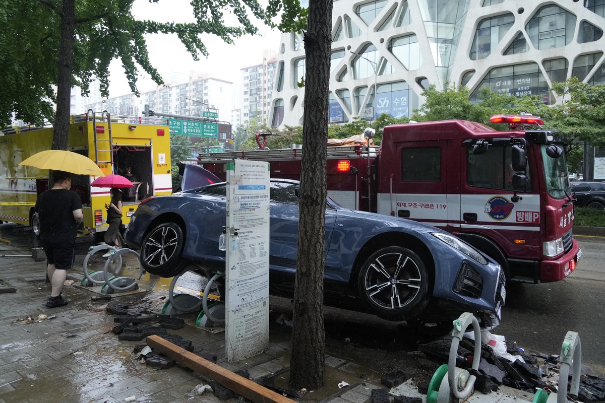 A vehicle sits damaged on a road after floating in heavy rainfall in Seoul, South Korea, Tuesday, Aug. 9, 2022. Heavy rains drenched South Korea's capital region, turning the streets of Seoul ...