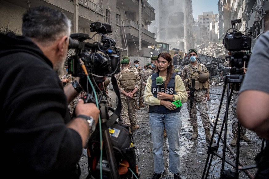 Lebanon at War in Nabatieh, Lebanon - 27 Oct 2024 A Russia Today journalist prepares to film a TV report on the site of an airstrike in Basta, central Beirut.
