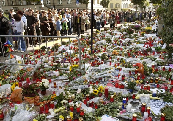 Residents of Zug, Switzerland remember the victims of the Thursday, Sept. 27, 2001 shooting with candles and flowers outside of the Parliament building in Zug, on Sunday, Sept. 30, 2001. A gunmen stor ...