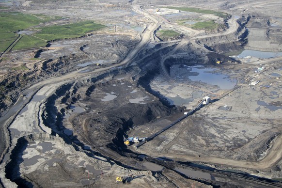 FILE - This June 25, 2008 photo shows an aerial view just north of Fort McMurray in Alberta, Canada, where the world's largest oil companies are building massive open pit mines to get at the oil sands ...