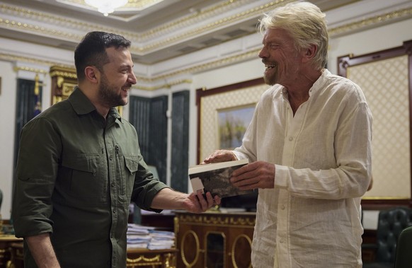 In this image provided by the Ukrainian Presidential Press Office, Ukrainian President Volodymyr Zelenskyy, left, and Virgin Galactic founder Richard Branson talk during their meeting in Kyiv, Ukraine ...