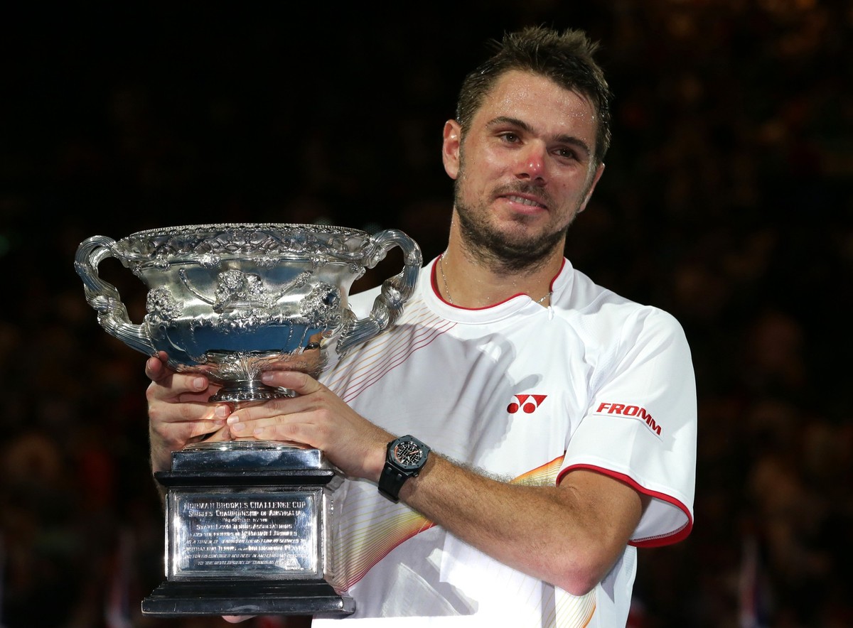 Stanislas Wawrinka of Switzerland holds the trophy after defeating Rafael Nadal of Spain during the men's singles final at the Australian Open tennis championship in Melbourne, Australia, Sunday, ...