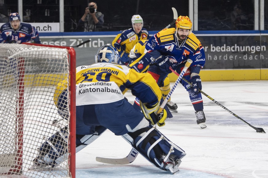 Zuerichs Top Scorer PostFinance Denis Hollenstein, rechts, kaempft um den Puck gegen Davos&#039; Goalie Sandro Aeschlimann, links, im Eishockeyspiel der National League zwischen den ZSC Lions und dem  ...