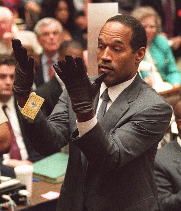.J. Simpson holds up his hands before the jury after putting on a new pair of gloves similar to the infamous bloody gloves during his double-murder trial in Losa Angeles on Wednesday, June 21, 1995. ( ...