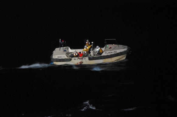 epa08643118 A handout photo made available by the Japan Coast Guard (JCG) 10th Coast Guard Headquarters shows Japan Coast Guard officers rescuing a Filipino crew member of the Gulf Livestock 1 cargo v ...