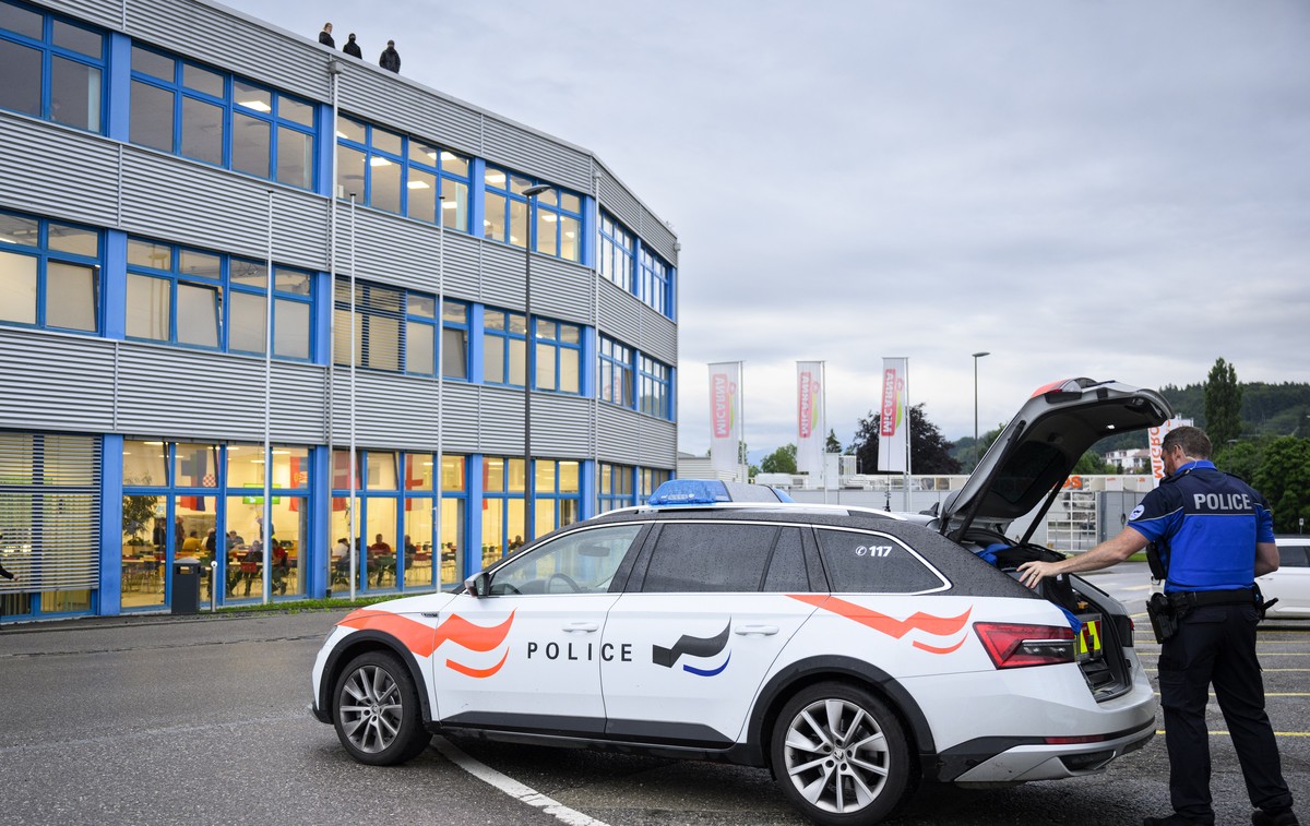 epa11449332 Police arrive at the spot as animal rights activists of the French association "269 Life Liberation Animale" demonstrate on the roof of Micarna slaughterhouses in Courtepin, Swit ...