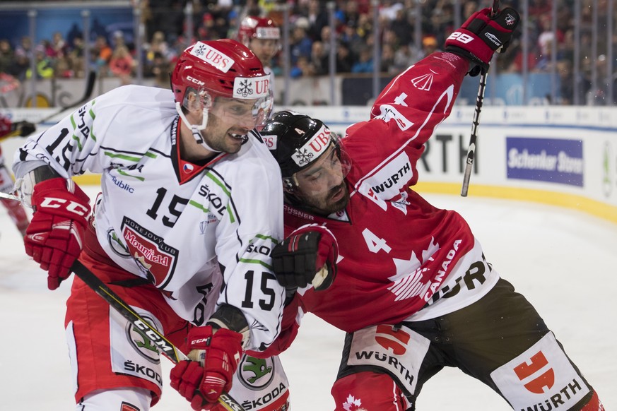 Mountfield&#039;s Blaz Gregorc, left, and Team Canada&#039;s Brandon Hickey fight for the puck during the game between Team Canada and Mountfield HK at the 91th Spengler Cup ice hockey tournament in D ...
