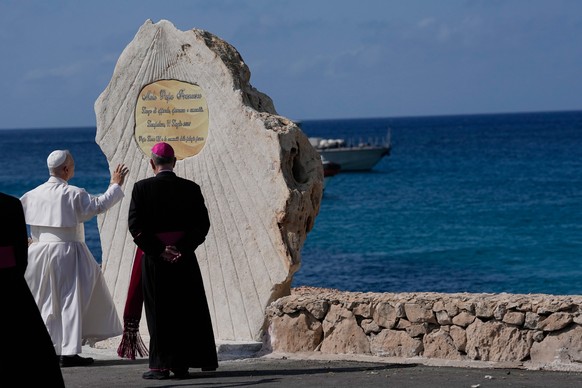 Pope Leo XIV blesses a plaque naming Molo Favaloro after Pope Francis in Lampedusa, Sicily, southern Italy, Saturday, July 4, 2026, during a one-day pastoral visit to the Sicilian island, a frequent l ...