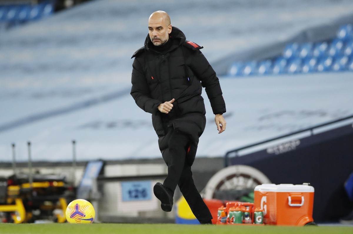epa08886130 Manchester City's manager Pep Guardiola kicks the ball during the English Premier League match between Manchester City and West Bromwich Albion FC in Manchester, Britain, 15 December  ...
