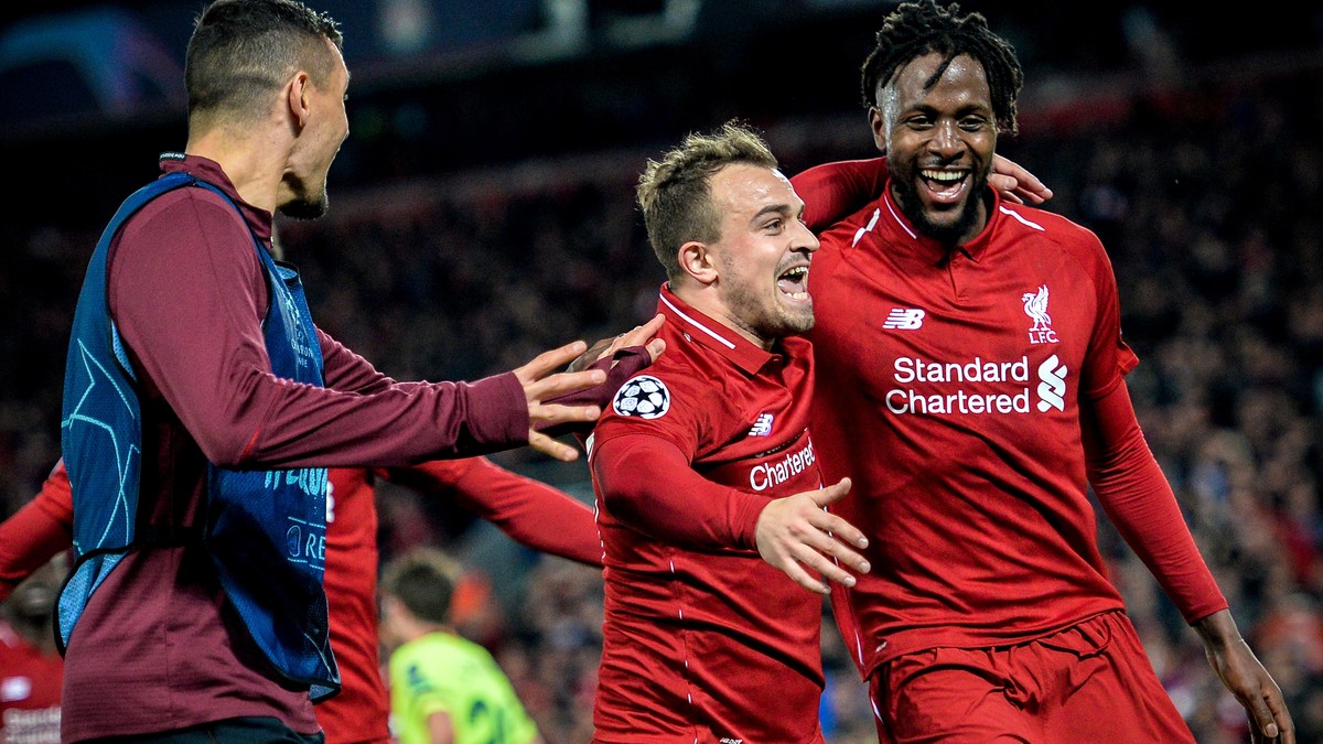 epa07554631 Liverpool's Divock Origi (R) celebrates with his teammate Xherdan Shaqiri (C) after scoring the 4-0 goal during the UEFA Champions League semi final second leg soccer match between Li ...
