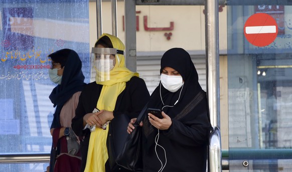 epa08744198 Iranian women wearing face masks wait in a bus station in a street of Tehran, Iran, 14 October 2020. According to the Iranian Health ministry, Iran reported its highest daily COVID-19 death toll by announcing 279 dead and 4830 new infections in the past 24 hours as it appears that Iran is in the grip of a third wave of COVID-19 outbreak.  EPA/ABEDIN TAHERKENAREH