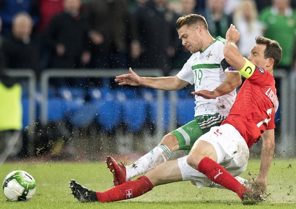 epa06325158 Northern Ireland&#039;s midfielder Jamie Ward (L) fights for the ball against Switzerland&#039;s defender Stephan Lichtsteiner during the 2018 Fifa World Cup play-offs second leg soccer ma ...