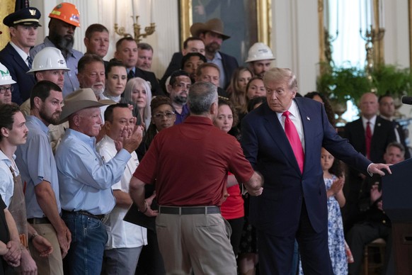 President Donald Trump, right, shakes the hand of Joe Abraham, father of Katie Abraham, during an event to promote Trump&#039;s domestic policy and budget agenda in the East Room of the White House, T ...