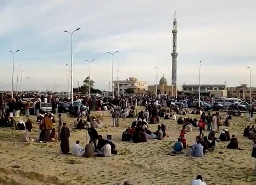 epa06348802 A grab image taken from taken from a video footage shows people gathering outside the mosque that was attacked in the northern city of Arish, Sinai Peninsula, Egypt, 24 November 2017. Acco ...