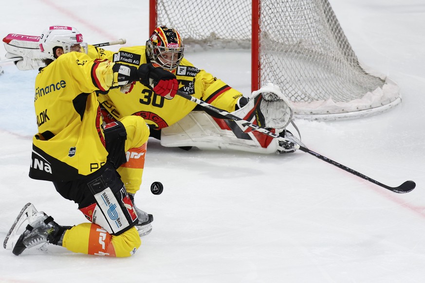 Lukas Klok (SCB) und Torhueter Philip Wuethrich (SCB) wehren einen Puck ab im sechsten Eishockey Playoff Viertelfinalspiel der National League zwischen dem HC Fribourg Gotteron und dem SC Bern, am Mon ...