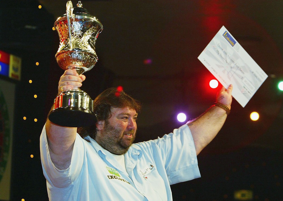 FRIMLEY GREEN, ENGLAND - JANUARY 11: Andy Fordham of England holds the trophy and winner's cheque after beating Mervyn King in the final of The BDO Lakeside World Darts Championships at the Lakes ...