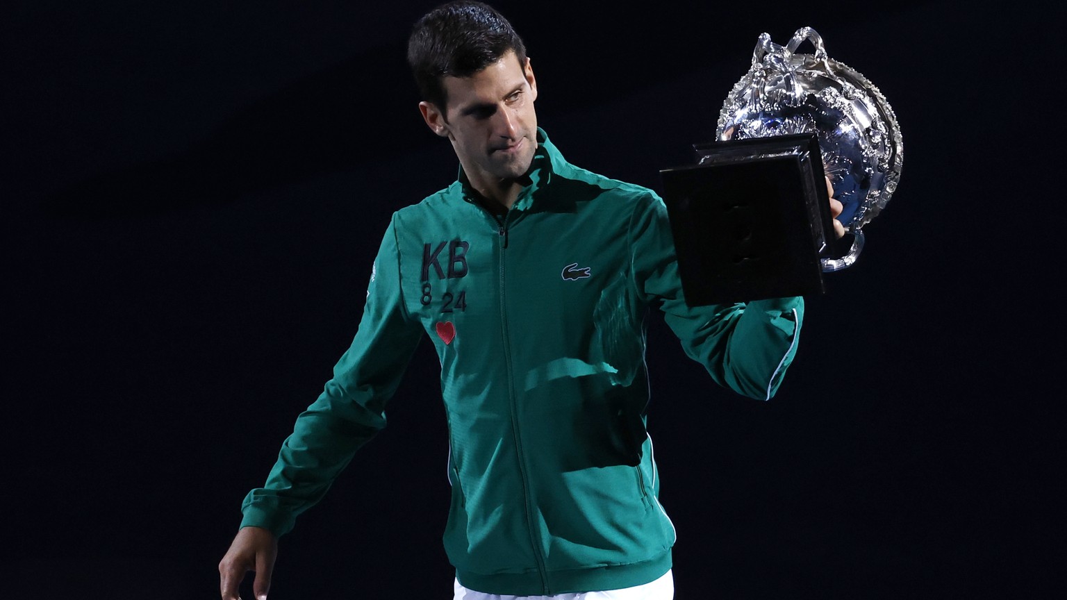 Serbia's Novak Djokovic carries the Norman Brookes Challenge Cup around Rod Laver Arena after defeating Austria's Dominic Thiem in the men's singles final of the Australian Open tennis championship in ...