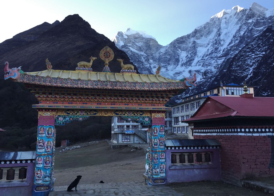 This April 7, 2016 photo shows the Buddhisdt monastery gate at the entrance to the small mountain village of Tengboche, elevation 12,664 feet (3,860 meters), at sunrise. Trekkers can attend daily Budd ...