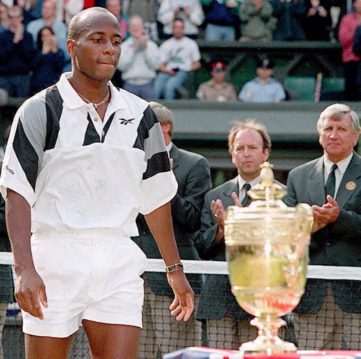 WIM22C-19960707-WIMBLEDON, United Kingdom: US MaliVai Washington looks at the Cup after his defeat against unseeded Richard Krajicek of the Netherlands in three sets 6-3, 6-4 and 6-3 in the Men's ...