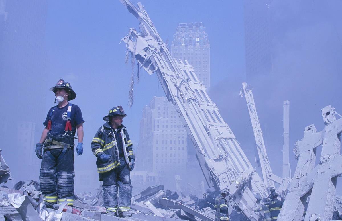 September 11, 2001, New York, New York, USA: New York Fire Department firemen climb the remains of the Marriott Hotel and the second tower to collapse in the afternoon of September 11, 2001 after the  ...