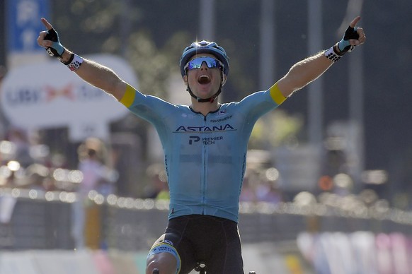 Jakob Fuglsang celebrates as he crosses the finish line to win the Tour of Lombardy cycling race, from Bergamo to Como, Italy, Saturday, Aug. 15, 2020. (Marco Alpozzi/LaPresse via AP)