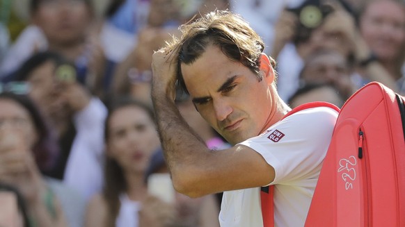 Switzerland&#039;s Roger Federer prepares to leave the court after losing his men&#039;s quarterfinals match against Kevin Anderson of South Africa, at the Wimbledon Tennis Championships, in London, W ...