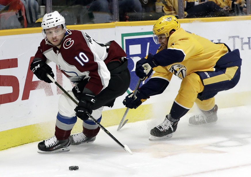 Colorado Avalanche right wing Sven Andrighetto (10), of the Czech Republic, beats Nashville Predators defenseman Yannick Weber, of Switzerland, to the puck during the third period of an NHL hockey gam ...