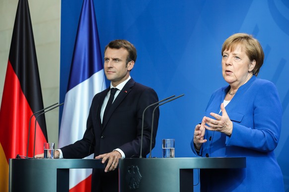 epa07536565 German Chancellor Angela Merkel (R) and French President Emmanuel Macron give a joint press statement during a &#039;Western Balkans Conference&#039; at the Chancellery in Berlin, Germany, ...