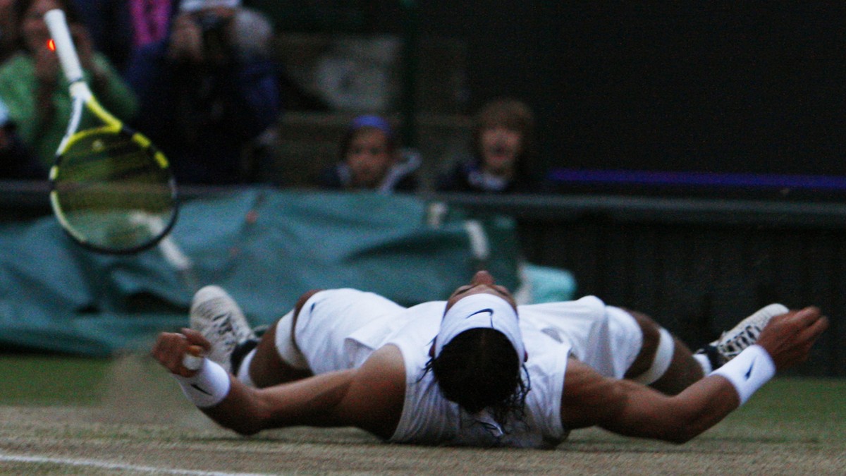 Spain's Rafael Nadal falls to the court after defeating Roger Federer, in the Men's Singles final on the Centre Court at Wimbledon, Sunday, July 6, 2008. (AP Photo/Alessia Pierdomenico, pool ...