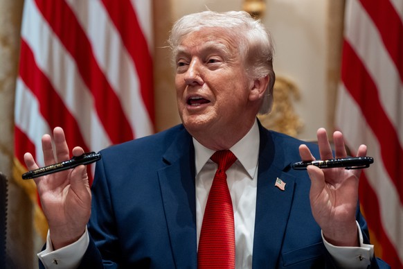 President Donald Trump holds up two Sharpie pens as he speaks during a Cabinet meeting at the White House, Thursday, March 26, 2026, in Washington. (AP Photo/Alex Brandon)
Donald Trump