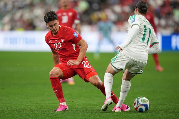 Switzerland's Fabian Rieder (22) battles for the ball with Algeria's Anis Hadj Moussa (11) during the World Cup round of 32 soccer match between Switzerland and Algeria in Vancouver, British ...