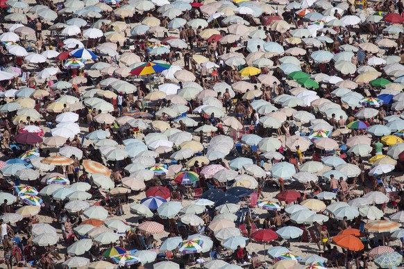 Thousands of beach goers pack Ipanema beach in Rio de Janeiro, Brazil, Sunday, Dec. 28, 2014. With temperatures reaching over 40 degrees celsius, (104 Fahrenheit), Rio beaches were packed on the last  ...