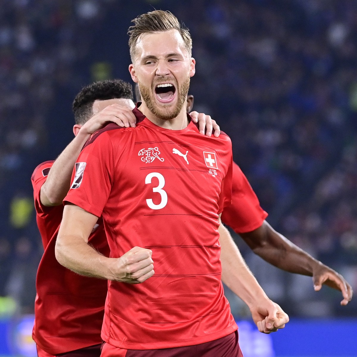 Switzerland's defender Silvan Widmer celebrates after scoring the opening goal during the 2022 FIFA World Cup European Qualifying Group C match between Italy and Switzerland at the Stadio Olimpic ...