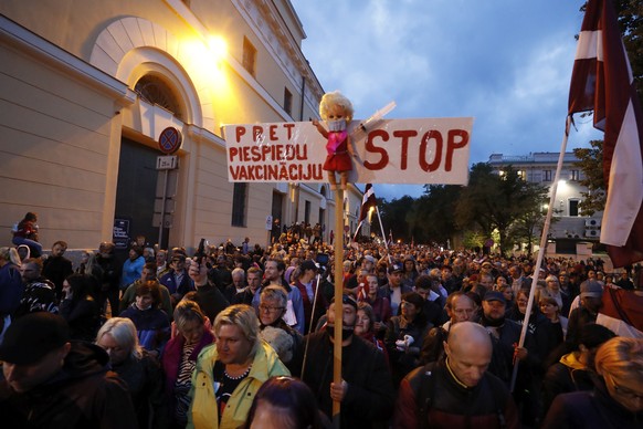 epa09419727 People during the protest against Covid-19 rules in Riga Old Town, Latvia, 18 August 2021. Several thousands of people had gathered in Rîga to protest against compulsory vaccinations again ...