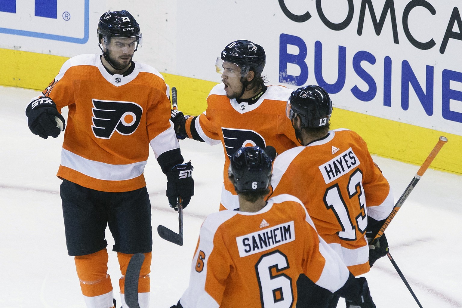 Philadelphia Flyers center Scott Laughton (21) celebrates his goal alongside teammates Travis Konecny (11), Kevin Hayes (13) and Travis Sanheim (6) during the third period of an NHL hockey playoff gam ...