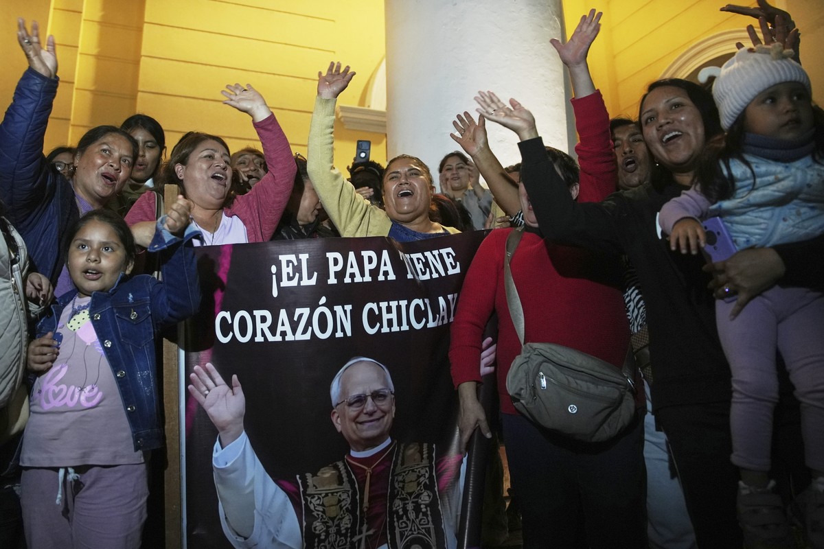 Parishioners hold a photo of Bishop Robert Prevost, elected Pope Leo XIV, after Mass at the Cathedral of Chiclayo, Peru, where he served as bishop for several years, Thursday, May 8, 2025. (AP Photo/G ...