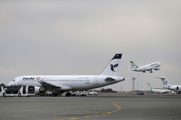 FILE - In this Feb. 7, 2016 file photo, an Iranian Mahan Air passenger plane takes off as a plane of Iran&#039;s national air carrier, Iran Air, is parked at left, at Mehrabad airport in Tehran, Iran. ...